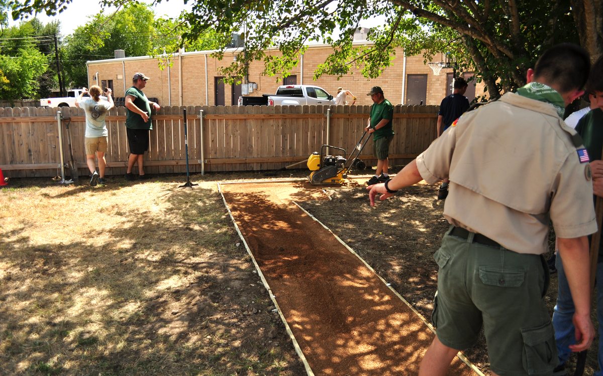 Gideon and volunteers building the pathway